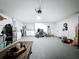 Well-lit garage with epoxy flooring, washer, dryer, and multiple work-from-home spaces at 1652 Larkin Rd, Spring Hill, FL 34608