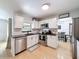 Well-lit kitchen with stainless steel appliances and an eat-in dining area at 1652 Larkin Rd, Spring Hill, FL 34608