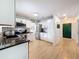 Modern kitchen with white cabinets, stainless steel appliances, and granite countertops at 1652 Larkin Rd, Spring Hill, FL 34608