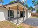 Inviting covered patio with ceiling fan and updated tile flooring; perfect for entertaining at 1652 Larkin Rd, Spring Hill, FL 34608