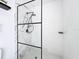 Stylish shower features marble wall design and sleek, black plumbing fixtures at 1652 Larkin Rd, Spring Hill, FL 34608