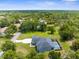 Aerial view of home featuring a screened in pool and lush landscaping at 2111 Maximilian Ave, Spring Hill, FL 34609