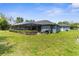 Well-maintained backyard with a view of the screened-in porch at 2111 Maximilian Ave, Spring Hill, FL 34609
