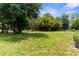 The expansive, well-maintained backyard offers plenty of space and mature trees for privacy at 2111 Maximilian Ave, Spring Hill, FL 34609