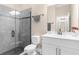 Clean bathroom featuring a single sink vanity, toilet and tiled walk-in shower at 2111 Maximilian Ave, Spring Hill, FL 34609