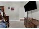 Bedroom featuring carpeting, a large dresser, bunk beds, and a mounted television at 2111 Maximilian Ave, Spring Hill, FL 34609