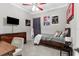 Cozy bedroom with carpet, ceiling fan, accent wall and decorative artwork at 2111 Maximilian Ave, Spring Hill, FL 34609