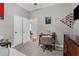 Bedroom with desk, chair, dresser, carpeted floors, and view into the hallway at 2111 Maximilian Ave, Spring Hill, FL 34609