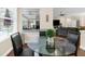 Breakfast nook with a glass table and views of the lanai from the window at 2111 Maximilian Ave, Spring Hill, FL 34609
