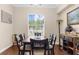 Traditional dining room with wood floors, a six seat table and a sunny window at 2111 Maximilian Ave, Spring Hill, FL 34609