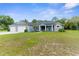 Charming single Gathering home featuring a well-manicured lawn, 3-car garage and inviting front porch at 2111 Maximilian Ave, Spring Hill, FL 34609