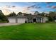 Charming single Gathering home featuring a well-manicured lawn, 3-car garage and inviting front porch at 2111 Maximilian Ave, Spring Hill, FL 34609