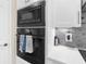 A wall oven with modern stainless steel appliances complemented by light countertops and backsplash at 2111 Maximilian Ave, Spring Hill, FL 34609