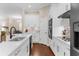 Elegant kitchen with white cabinetry, stainless steel appliances, and a spacious center island at 2111 Maximilian Ave, Spring Hill, FL 34609