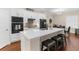 Kitchen boasts ample counter space, modern appliances, barstool seating, and white cabinetry at 2111 Maximilian Ave, Spring Hill, FL 34609