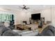 Inviting living room with a cozy fireplace, plush seating, and a sliding door leading to outdoor space at 2111 Maximilian Ave, Spring Hill, FL 34609