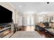 Spacious living room with wood floors and an electric fireplace, adjacent to the front entryway at 2111 Maximilian Ave, Spring Hill, FL 34609
