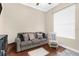 Relaxing living room with grey sofa, throw pillows, area rugs, and a bright window at 2111 Maximilian Ave, Spring Hill, FL 34609