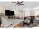Inviting living room boasts a fireplace, ceiling fan, and ample seating for relaxation and gatherings at 2111 Maximilian Ave, Spring Hill, FL 34609