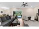 Living room with outside access to a pool and lanai; features a ceiling fan and neutral paint at 2111 Maximilian Ave, Spring Hill, FL 34609