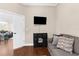 Cozy sitting room with dark wood floors, sofa, and mounted television for relaxed living at 2111 Maximilian Ave, Spring Hill, FL 34609