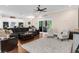Inviting living room with a large rug, hardwood floors, and neutral decor that creates a cozy atmosphere at 2111 Maximilian Ave, Spring Hill, FL 34609