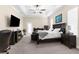 Spacious main bedroom featuring a tray ceiling, an ensuite bathroom and a walk-in closet at 2111 Maximilian Ave, Spring Hill, FL 34609