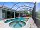 Screened pool with hot tub and sun loungers. Donut inflatables in pool at 2111 Maximilian Ave, Spring Hill, FL 34609