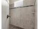Beautifully tiled shower with stone floor and shower head at 2111 Maximilian Ave, Spring Hill, FL 34609