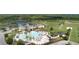 Aerial view showcasing a stunning community center with a pool, water park, and lush landscaping at 22289 Nebula Way, Land O Lakes, FL 34637