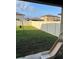 Spacious backyard with a white fence, green grass, and play equipment at 22289 Nebula Way, Land O Lakes, FL 34637