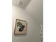 Close-up of a bathroom wall featuring a framed plant picture and vent at 22289 Nebula Way, Land O Lakes, FL 34637