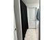 Bathroom featuring a neutral tile floor and a door with a blue towel hanging behind it at 22289 Nebula Way, Land O Lakes, FL 34637