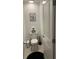 Small powder room with toilet, toilet paper holder, and black and white decor at 22289 Nebula Way, Land O Lakes, FL 34637