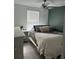 Cozy bedroom with a ceiling fan, a dresser, and a 'cozy' pillow at 22289 Nebula Way, Land O Lakes, FL 34637