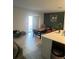 Open dining area features a modern table set adjacent to the kitchen, offering a spacious and welcoming environment at 22289 Nebula Way, Land O Lakes, FL 34637