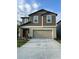 Inviting two-story home featuring a neutral color palette, a two-car garage, and a well-maintained front yard at 22289 Nebula Way, Land O Lakes, FL 34637