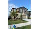 Charming two-story home with a well-manicured lawn, landscaping, and a two-car garage at 22289 Nebula Way, Land O Lakes, FL 34637