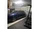 A clean garage featuring ample space, a parked SUV, and home gym equipment at 22289 Nebula Way, Land O Lakes, FL 34637