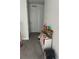 Hallway with gray carpet and a white door and toys at 22289 Nebula Way, Land O Lakes, FL 34637