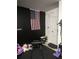 Custom home gym area featuring a black accent wall and workout equipment at 22289 Nebula Way, Land O Lakes, FL 34637