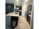Modern kitchen boasts dark cabinetry, stainless steel appliances, a large center island, and a seamless layout at 22289 Nebula Way, Land O Lakes, FL 34637