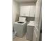 Bright laundry room featuring a washer, dryer, and storage cabinets at 22289 Nebula Way, Land O Lakes, FL 34637