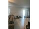 A neutral living room connects to the dining area, showing continuity and modern design with natural light at 22289 Nebula Way, Land O Lakes, FL 34637
