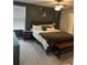 Inviting main bedroom with a cozy bed, dark nightstand, and neutral tones, providing a peaceful and stylish space at 22289 Nebula Way, Land O Lakes, FL 34637