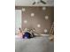 Playroom area featuring daisy decals on a brown wall and a wooden climber at 22289 Nebula Way, Land O Lakes, FL 34637