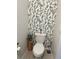 Decorated powder room featuring a toilet, toilet paper and elegant botanical wallpaper at 22289 Nebula Way, Land O Lakes, FL 34637