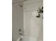 Shower with subway tile, brushed chrome fixtures, and a built-in shelf at 22289 Nebula Way, Land O Lakes, FL 34637