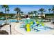 Community water park and swimming pool, complete with slides, fountains, and palm trees at 22289 Nebula Way, Land O Lakes, FL 34637