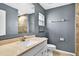 Bathroom featuring a modern vanity, sink, tiled floors, and a walk-in shower at 2476 Magellan Ave, Spring Hill, FL 34608